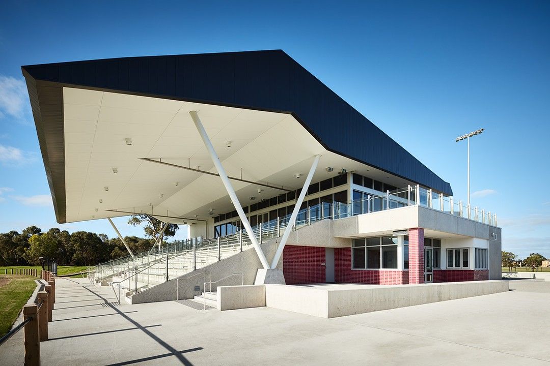 A large building with a black roof and stairs