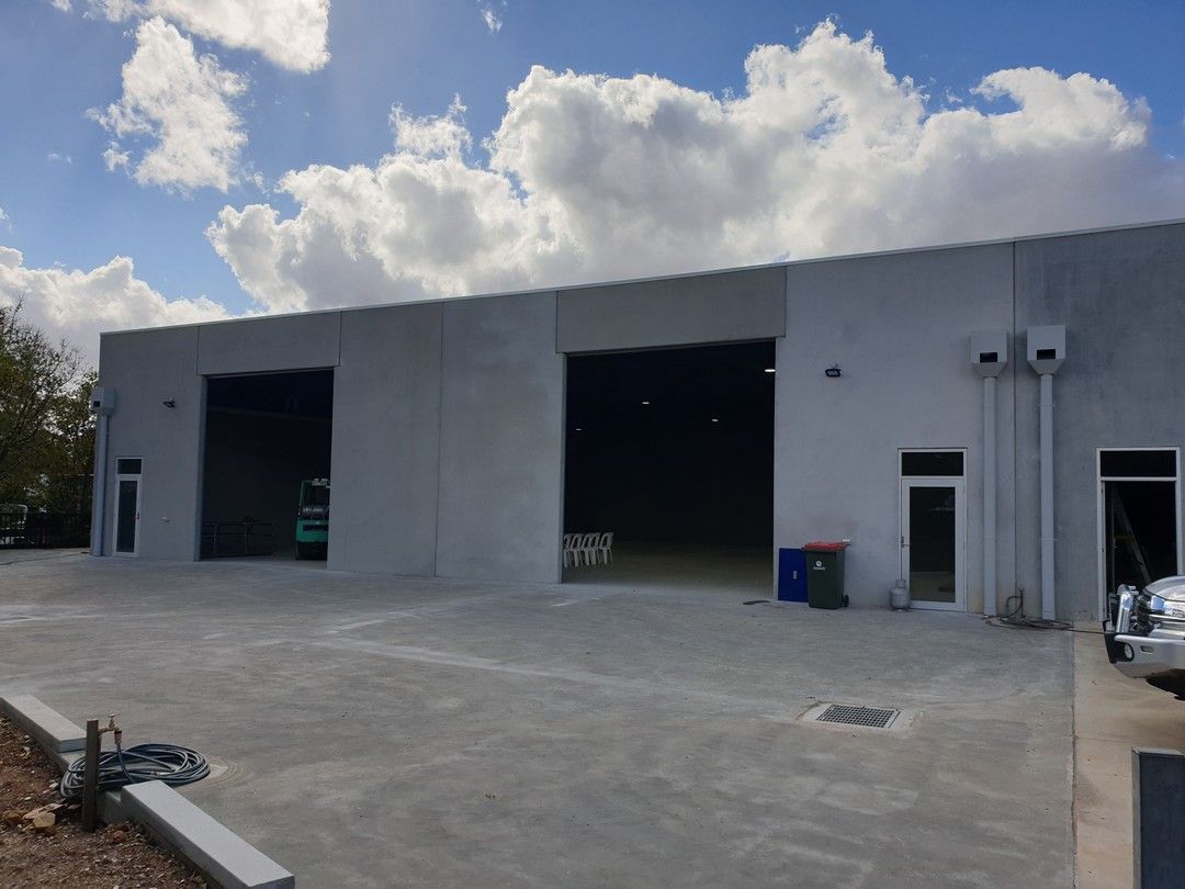 A large white building with a lot of doors and windows