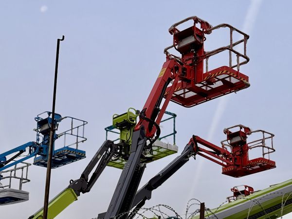 Eyecatching and colorful lifting equipment can be seen at this busy construction site. Eyecatching and colorful lifting equipment can be seen at this busy construction site.