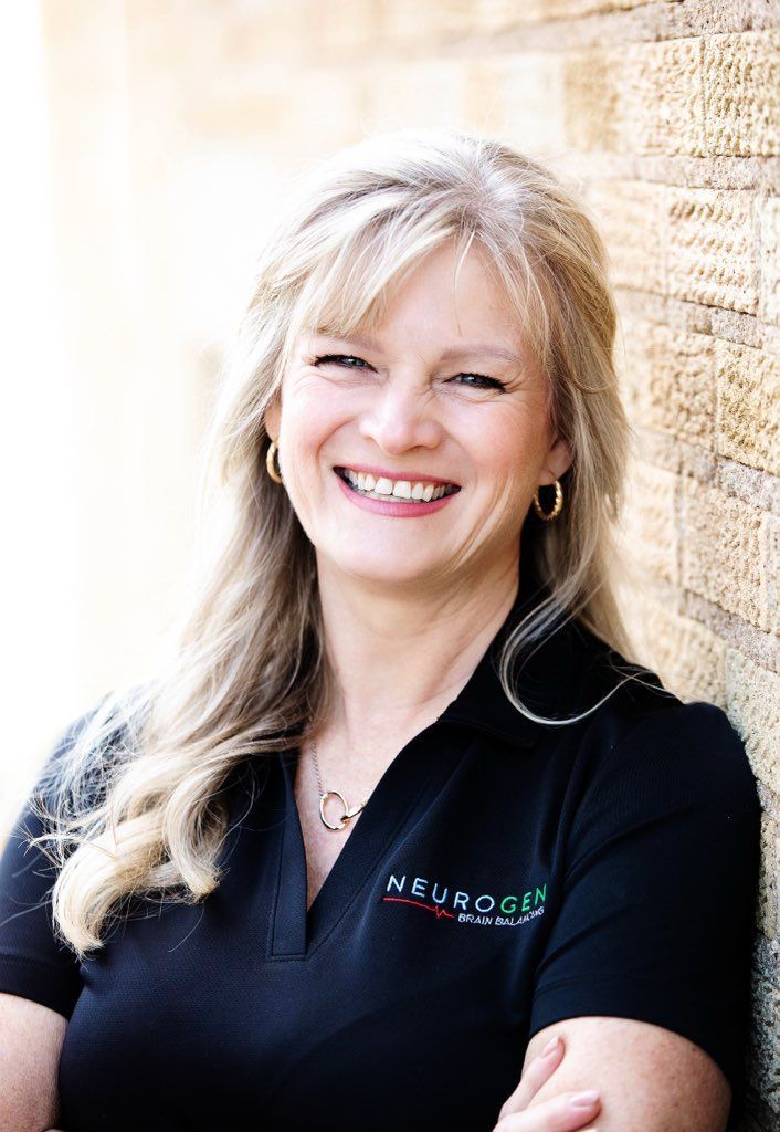 A woman with long blonde hair is smiling for the camera.
