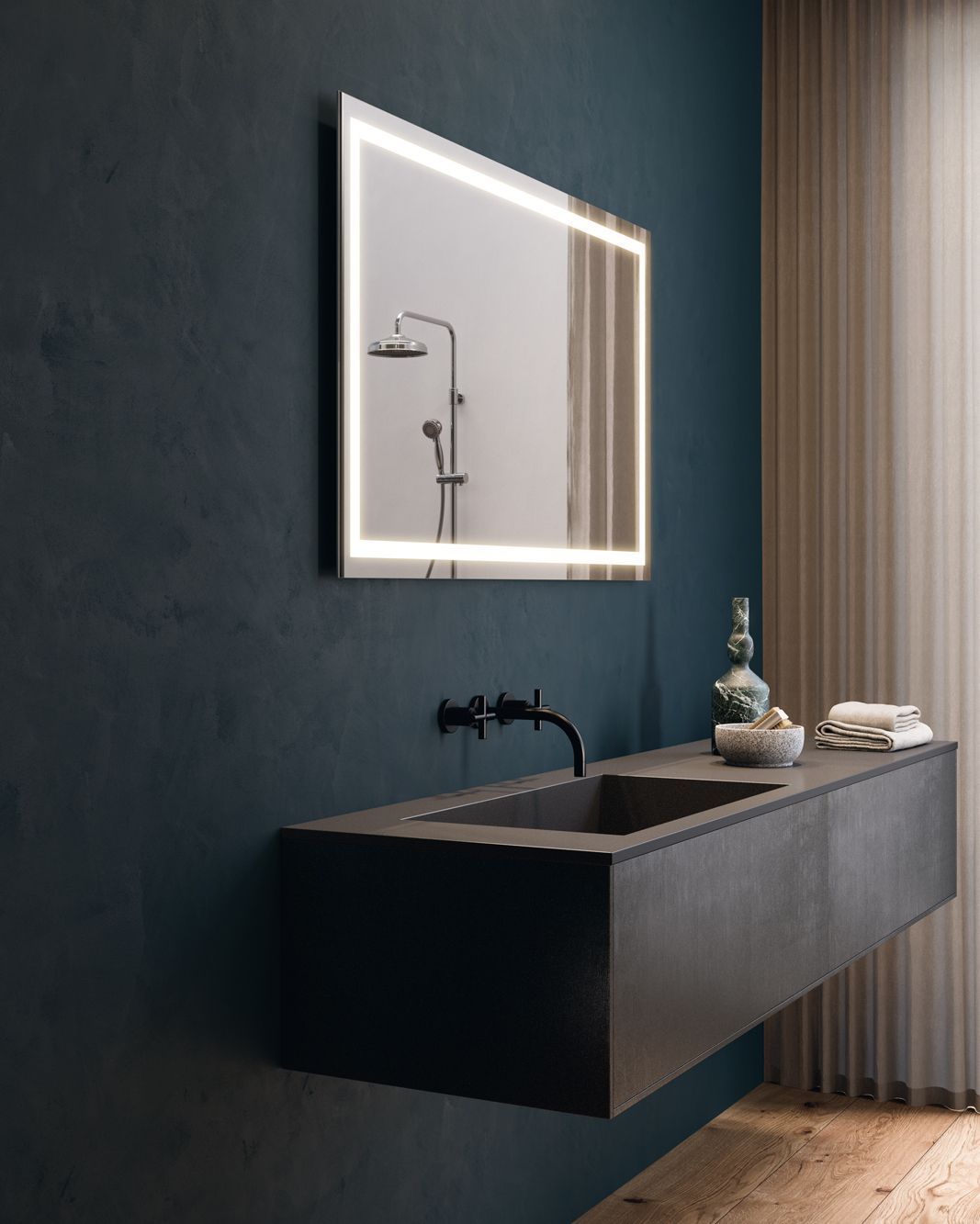 Bagno moderno con specchio retroilluminato sopra un lavandino sospeso grigio scuro.