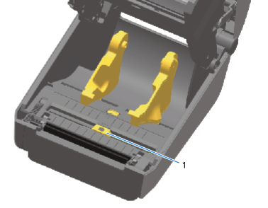 Inside of a thermal label printer showing two yellow media holders and a movable sensor labeled 