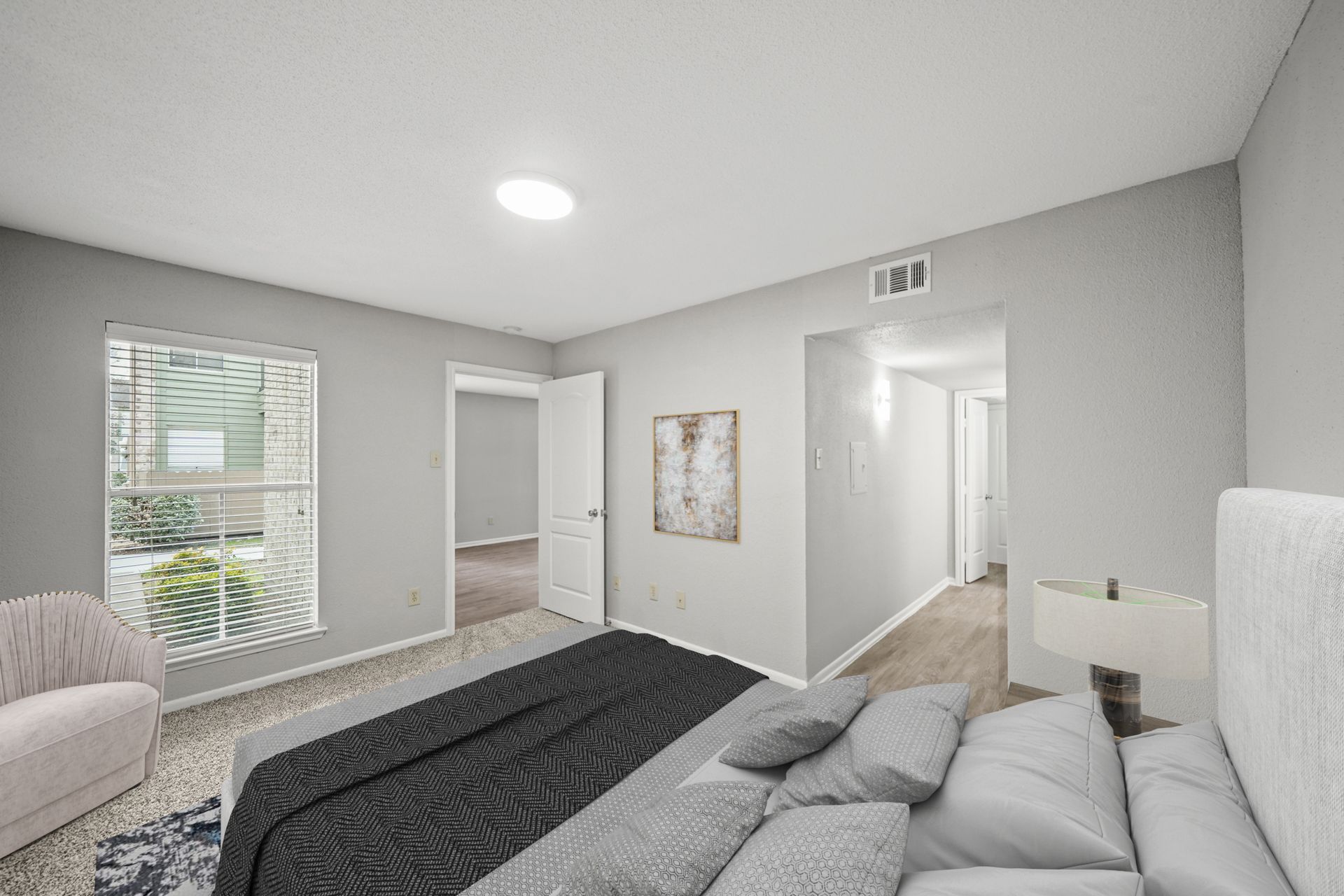 A bedroom with a large bed and a couch.