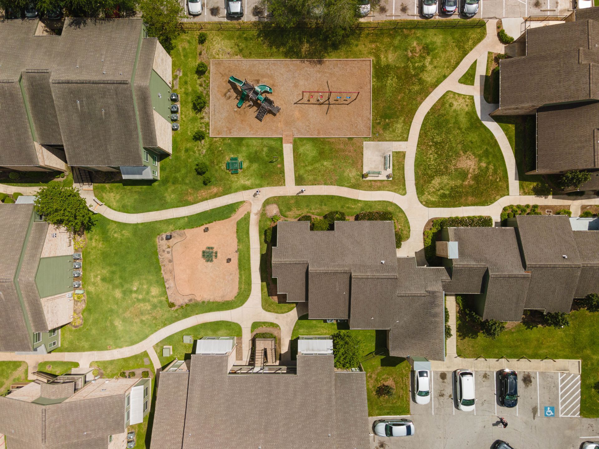 An aerial view of a residential area with houses and a playground