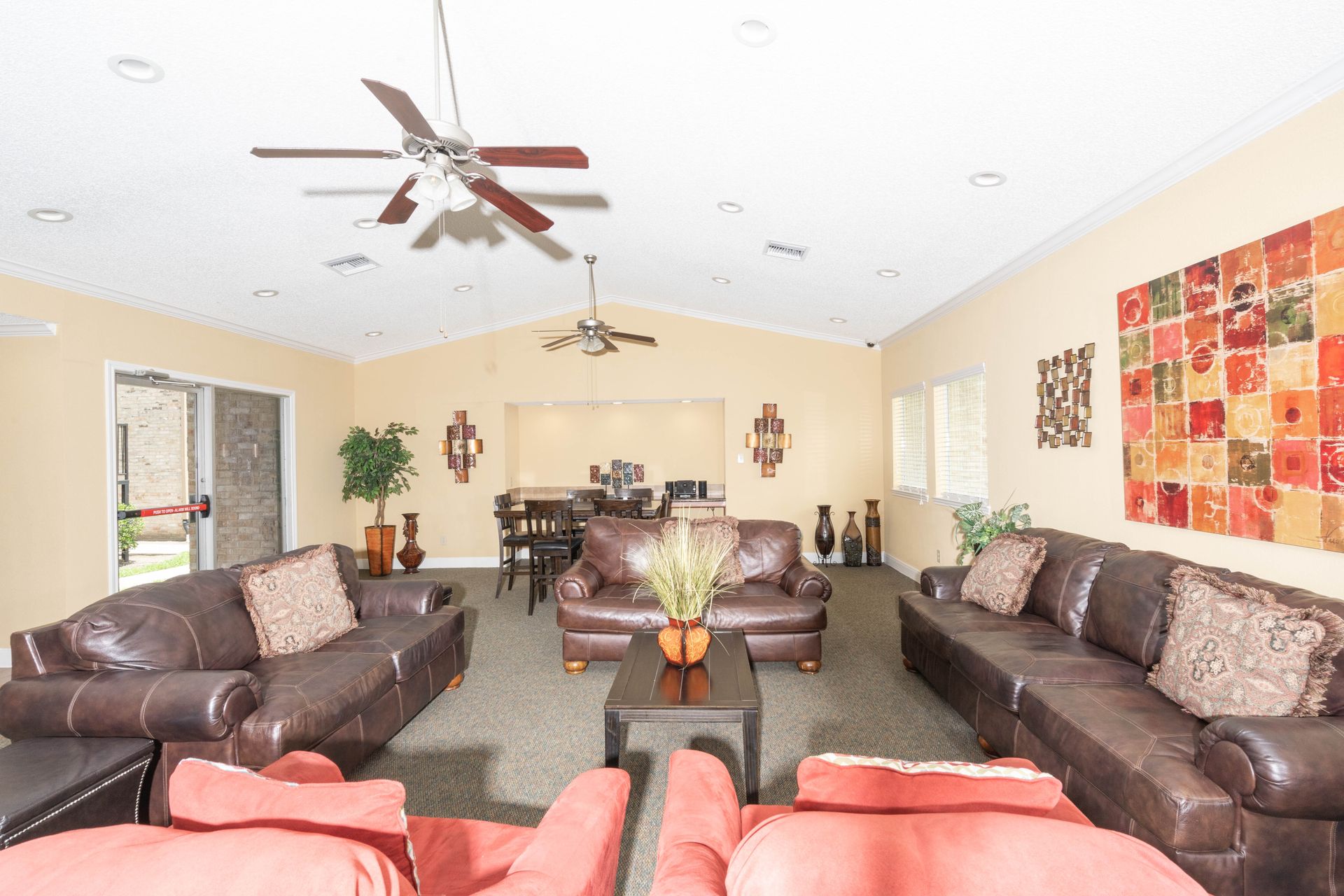 A living room filled with furniture and a ceiling fan