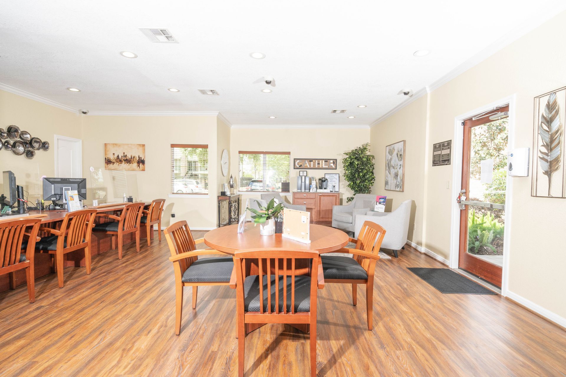 There is a table and chairs in the middle of the room.