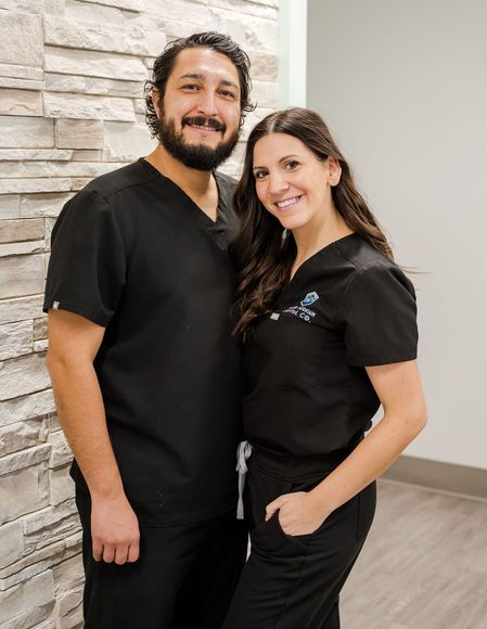 Dr. Sisneros and his wife smiling at the camera