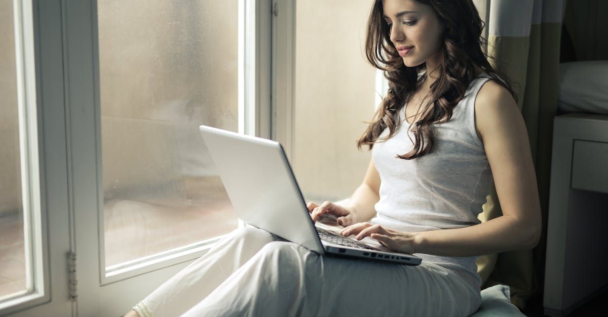 Women sitting at a window with a laptop