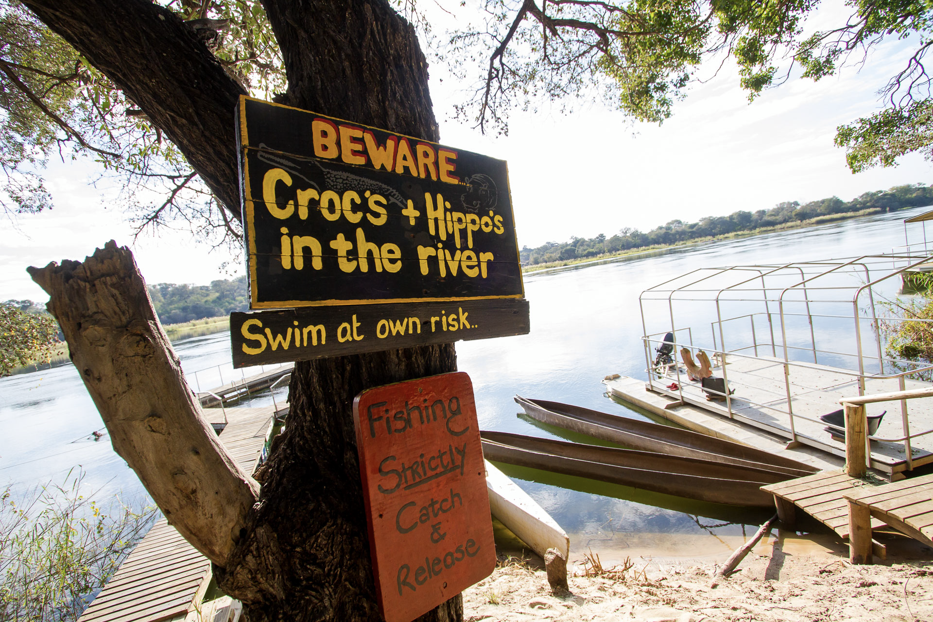 a sign that says beware crocs and hippos in the river