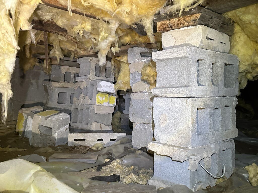A pile of concrete blocks stacked on top of each other in a basement.