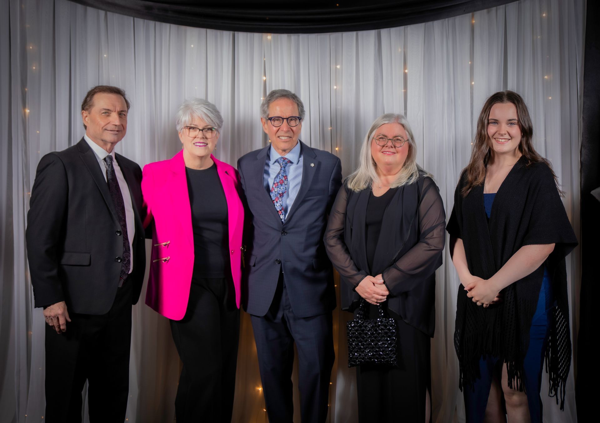 Five people pose for a photo.