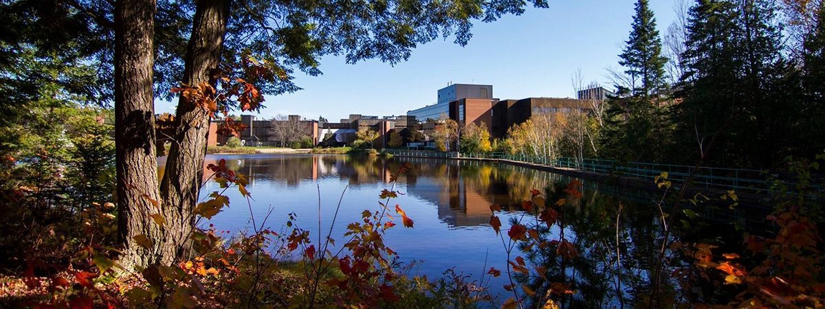 Photograph of campus from across the pond in autumn