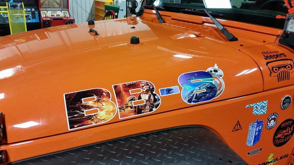 Orange Jeep hood with Star Wars BB-8 stickers.