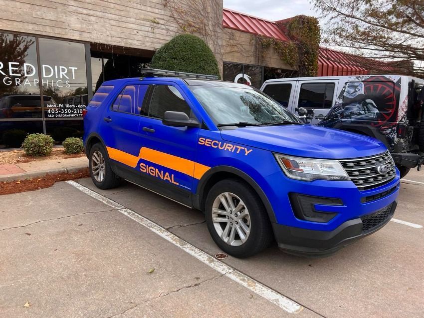 Blue security SUV with orange stripe and 