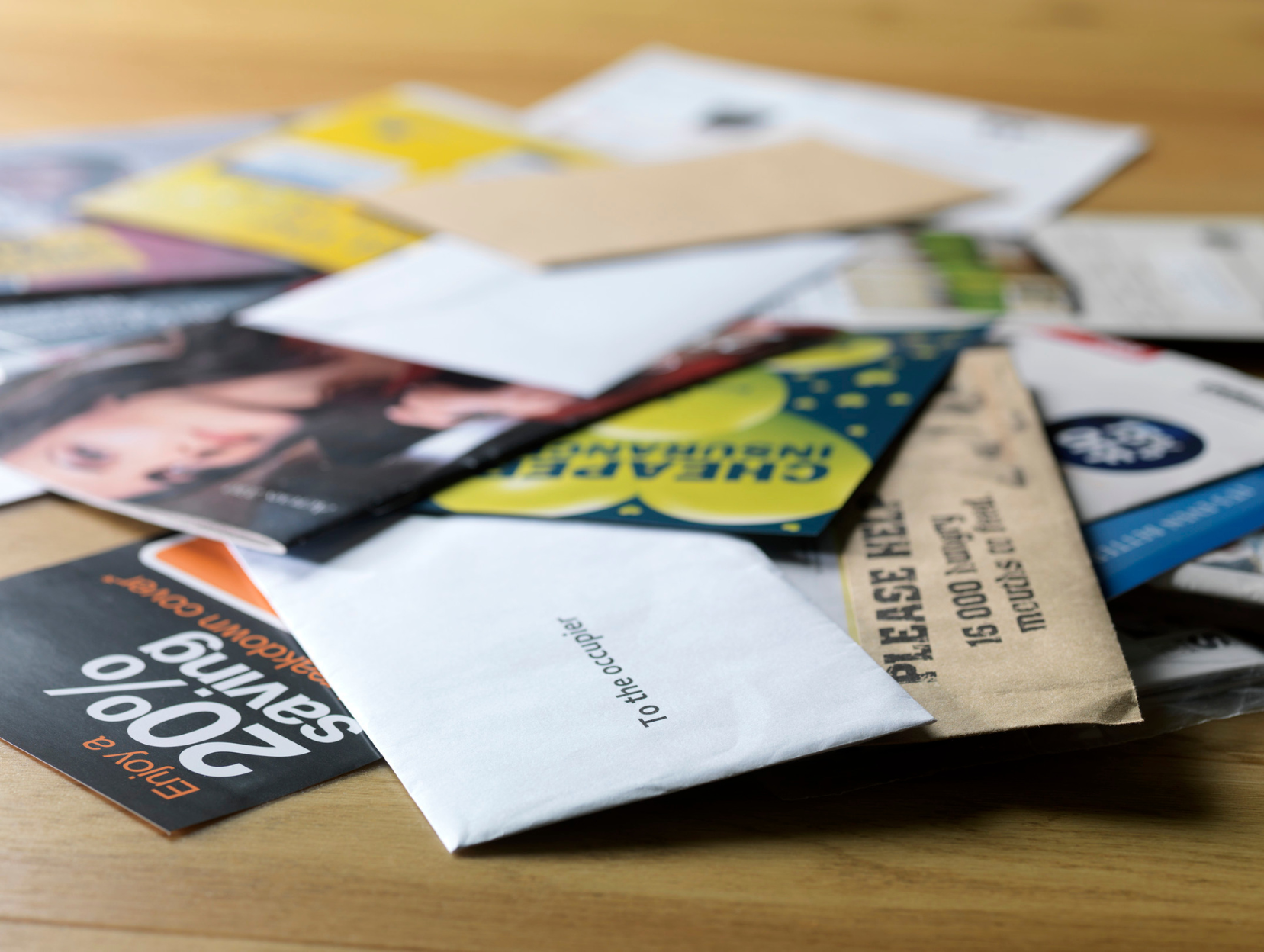 A pile of envelopes including one that says 20 % saving