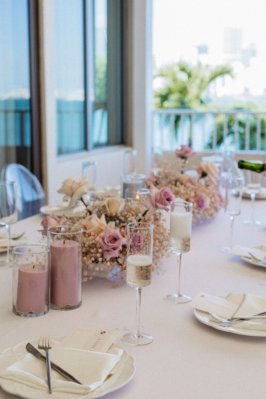 A table with plates, candles, wine glasses and flowers on it. A table with plates, candles, wine glasses and flowers on it.