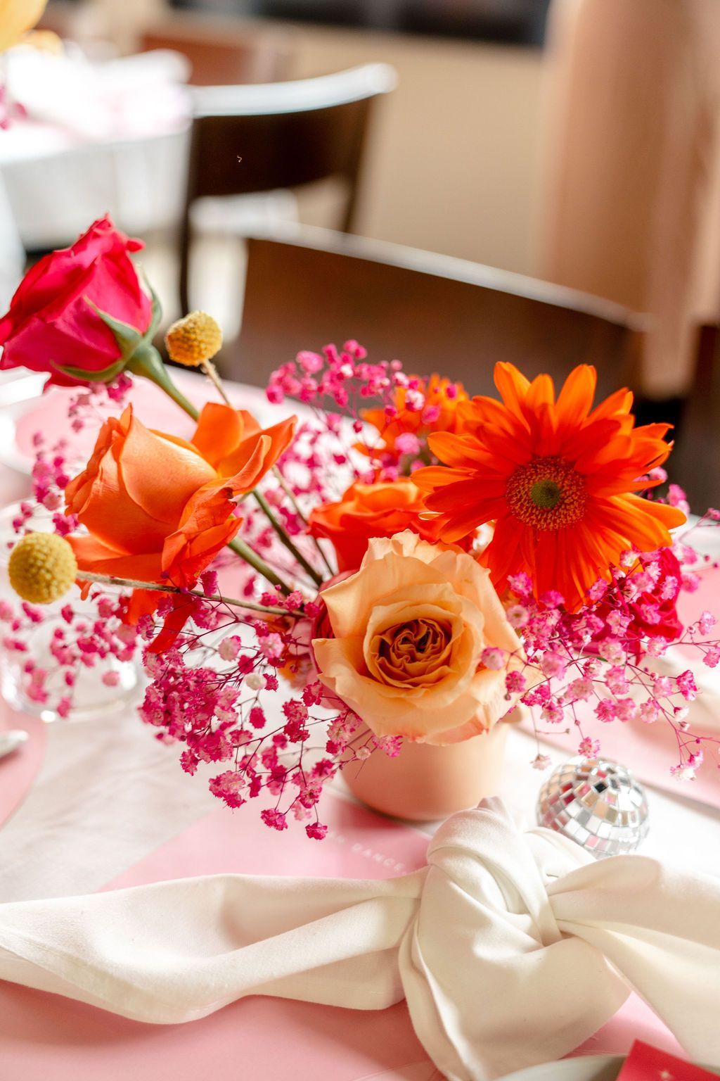 A table with flowers and a napkin on it A table with flowers and a napkin on it