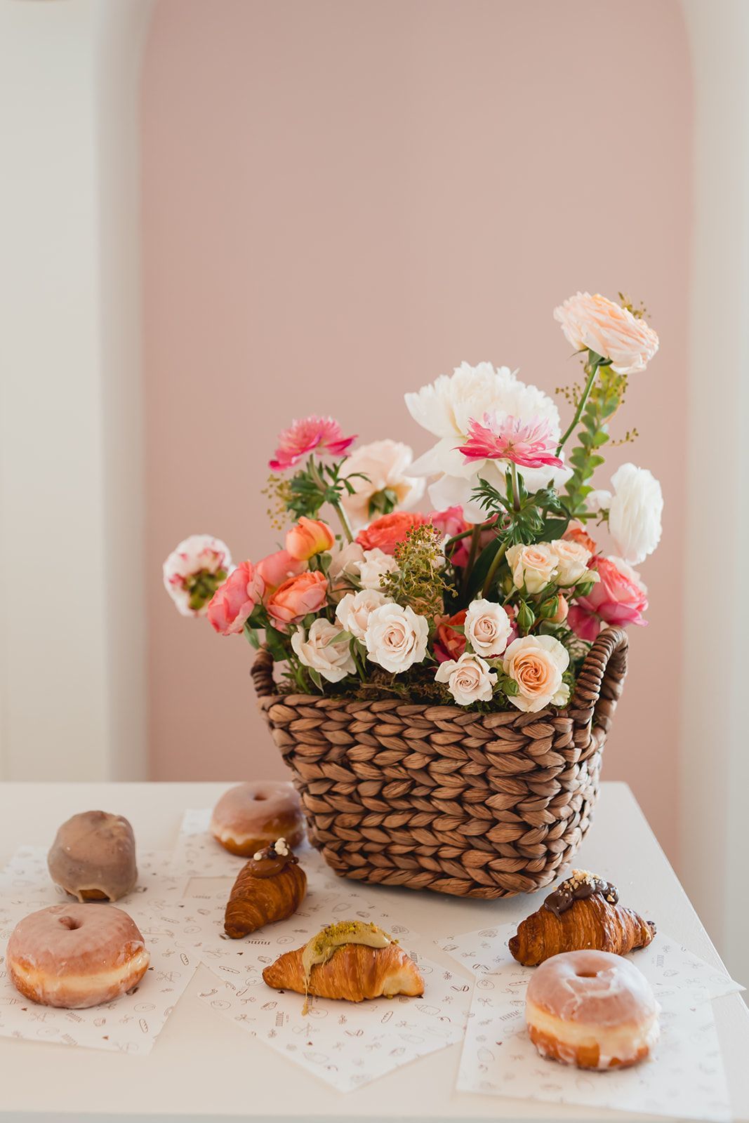 A long table with plates, utensils, and flowers on it. A long table with plates, utensils, and flowers on it.