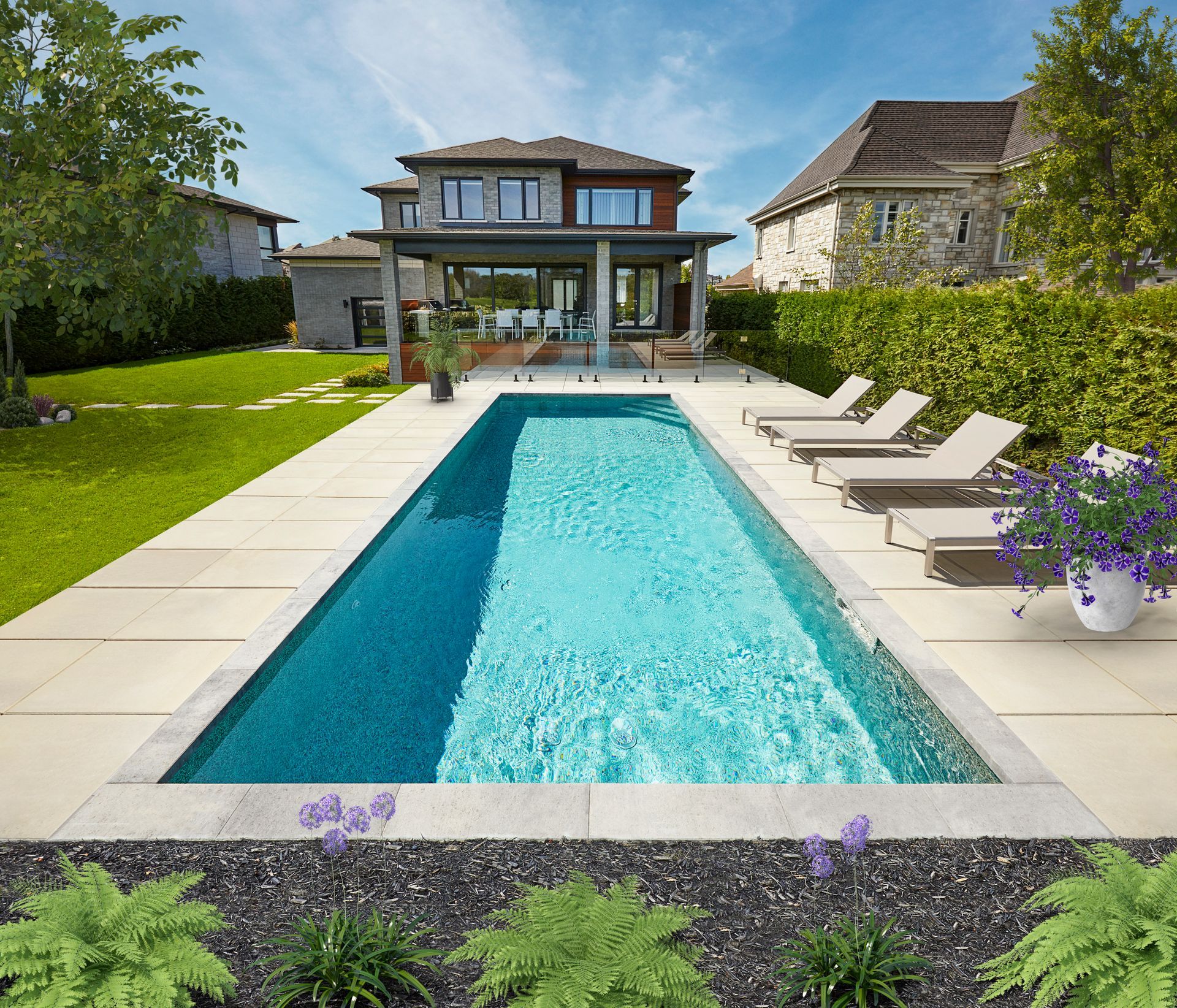 Poolside lounge area with sofas, umbrellas, and a view of trees and the sky.