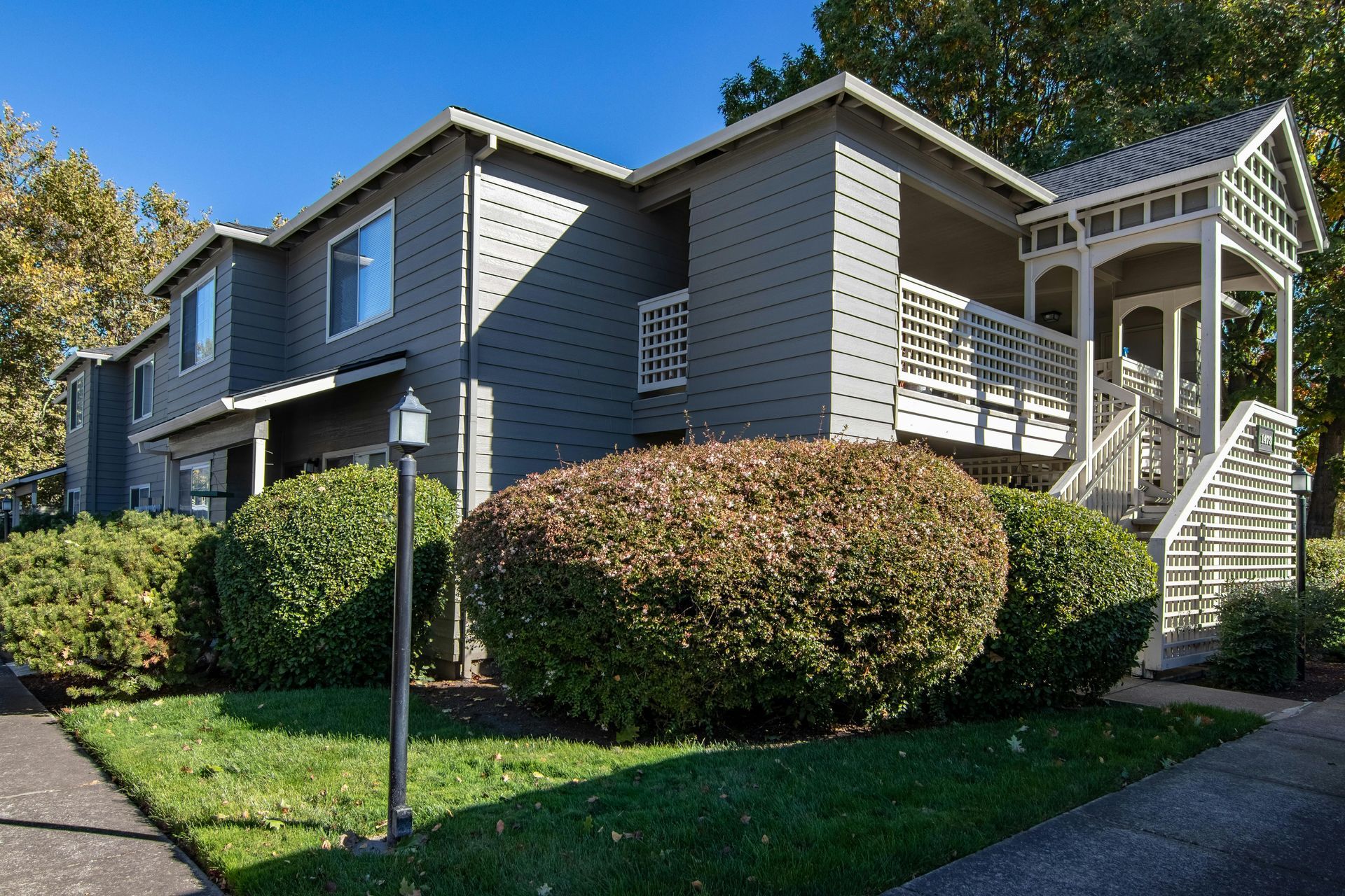A large gray house with a porch and stairs