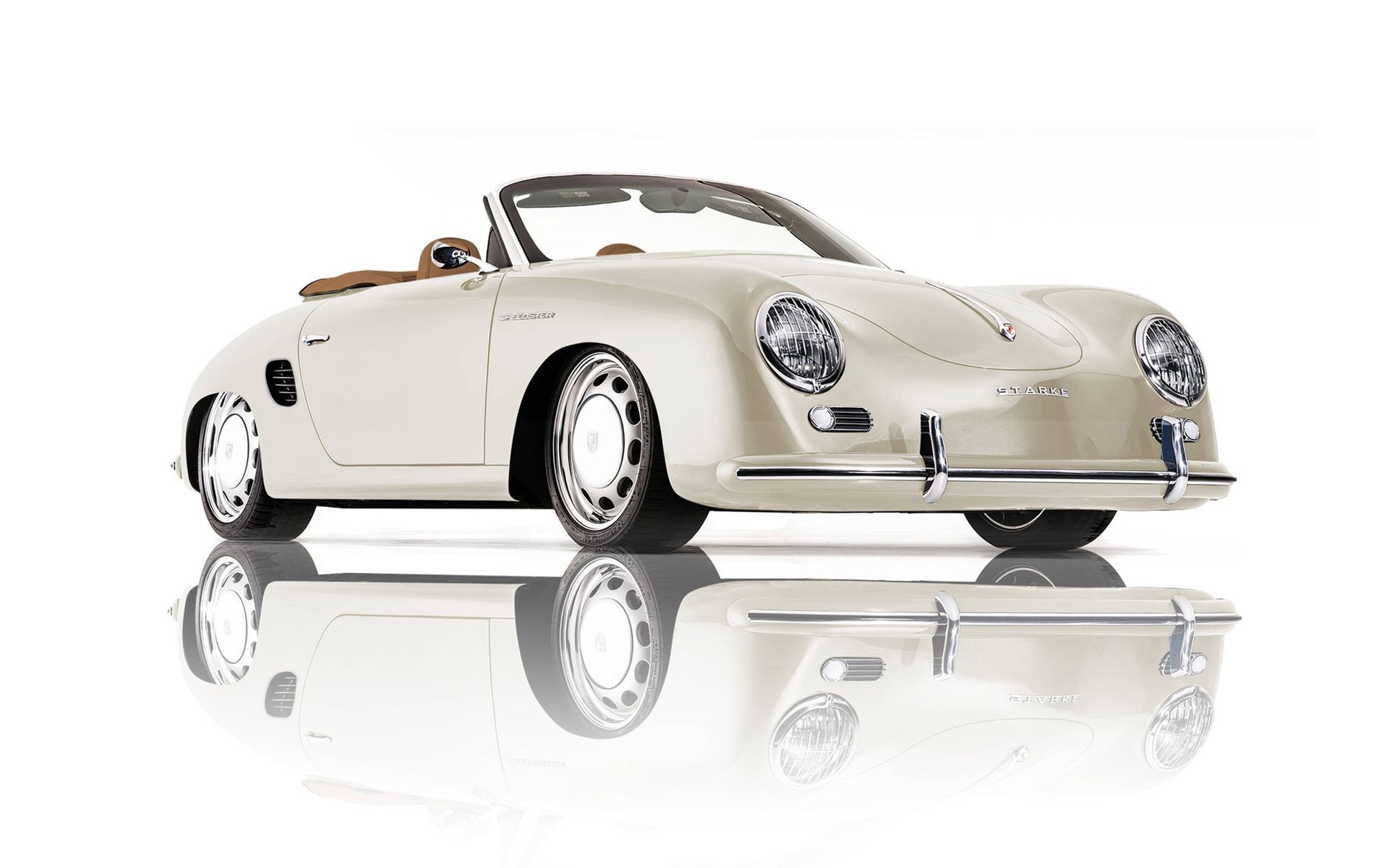 A white porsche speedster is sitting on a white surface with a reflection.