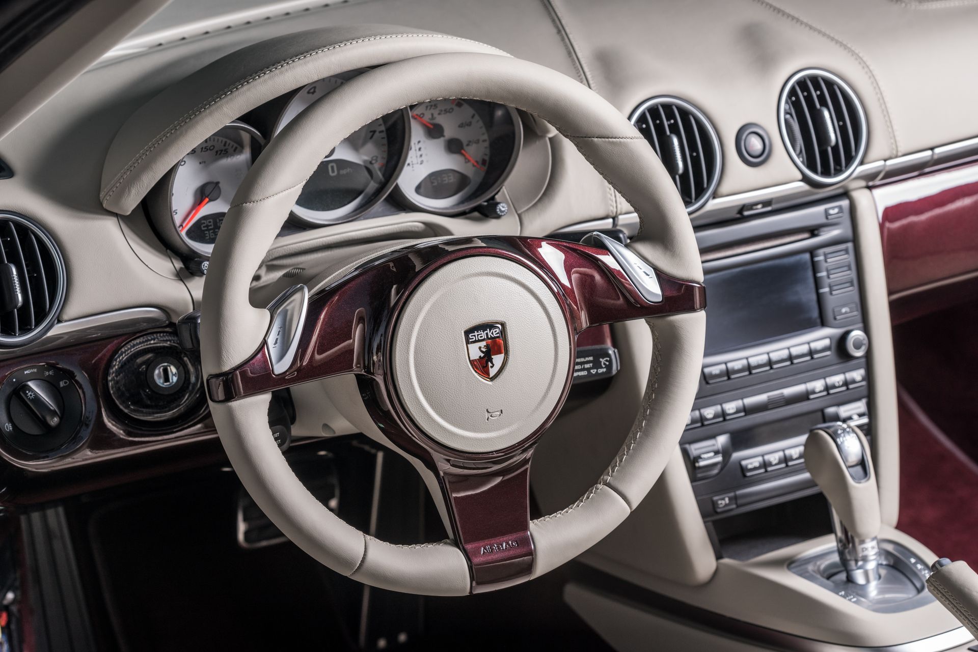 A steering wheel with a porsche logo on it