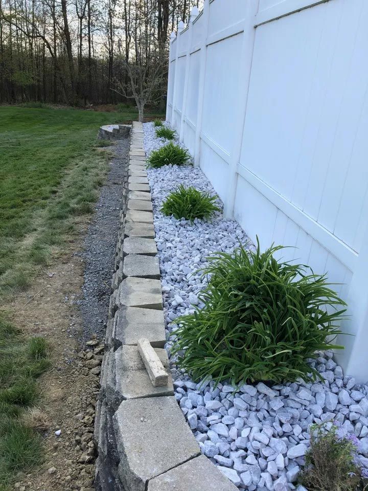 White Fence with Border of Cobblestones — West Middlesex, PA — Z'Crete Concrete & Excavation LLC