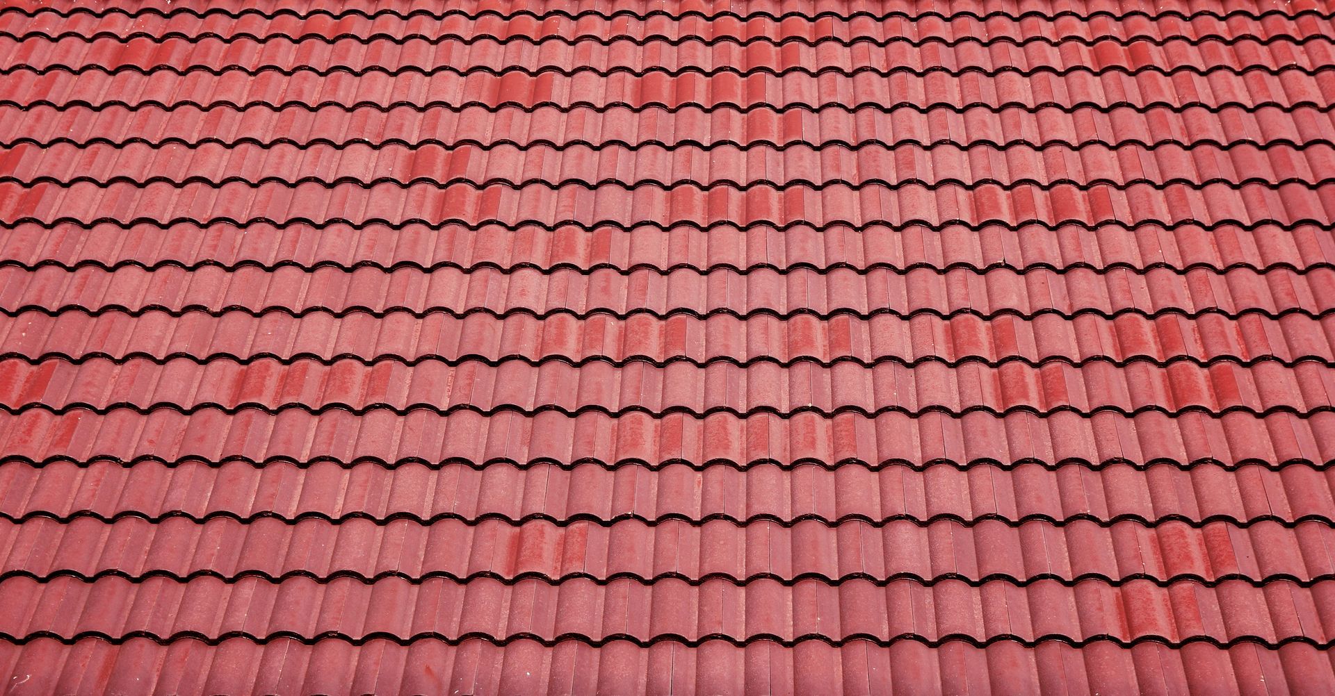 Red tiled roof. Rows of overlapping tiles with a wavy, textured design.
