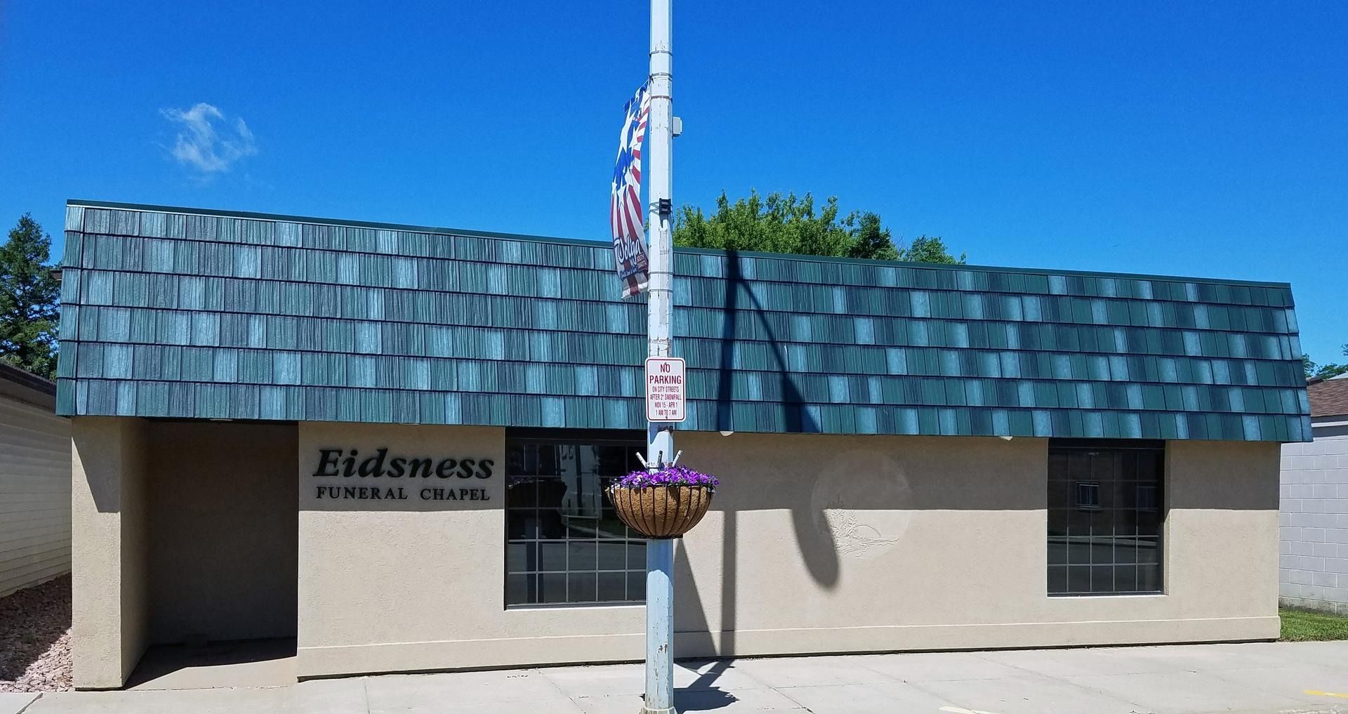 Tan building with blue shingle roof,