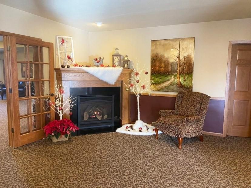 An artist 's impression of a hotel lobby with a couch , chairs , and plants.