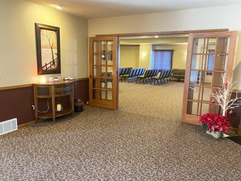 A church with rows of wooden benches and a podium