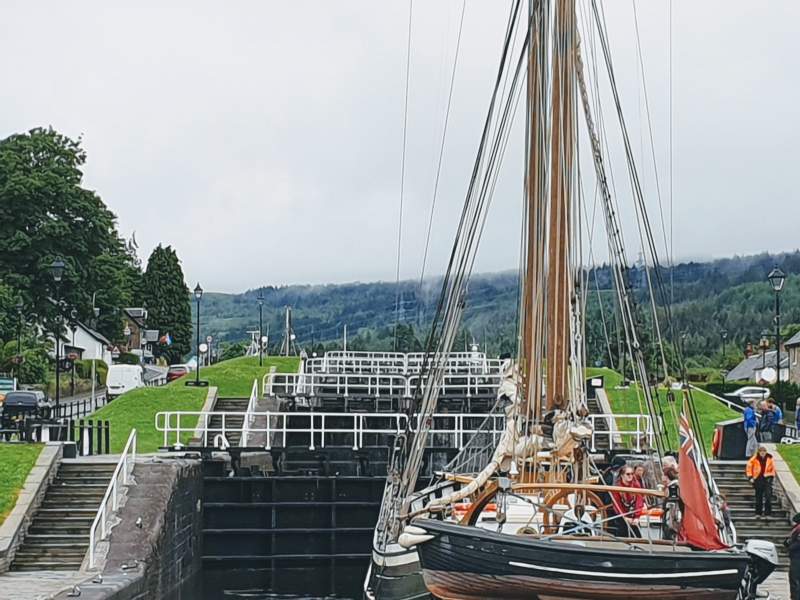 Boat going through the Caledonian Canal ladder of locks Fort Augustus Highlands Scotland
