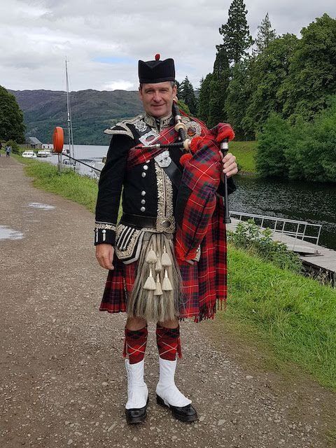 A Scottish Piper in Fort Augustus by the Caledonian Canal
