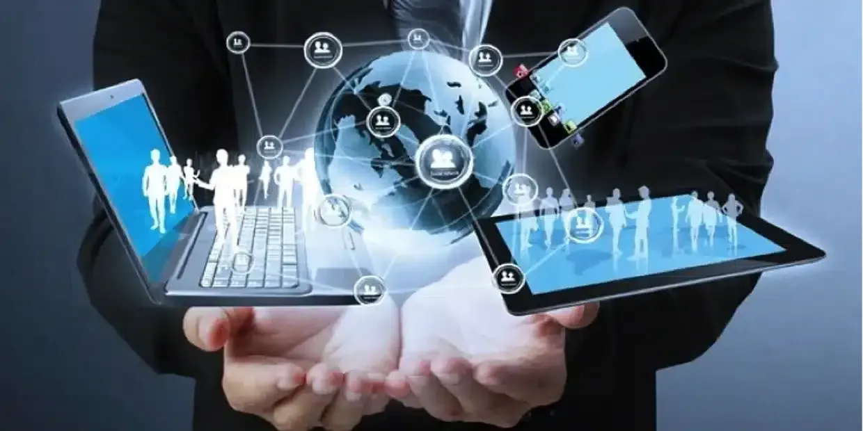 A man is holding a laptop and a tablet in his hands.