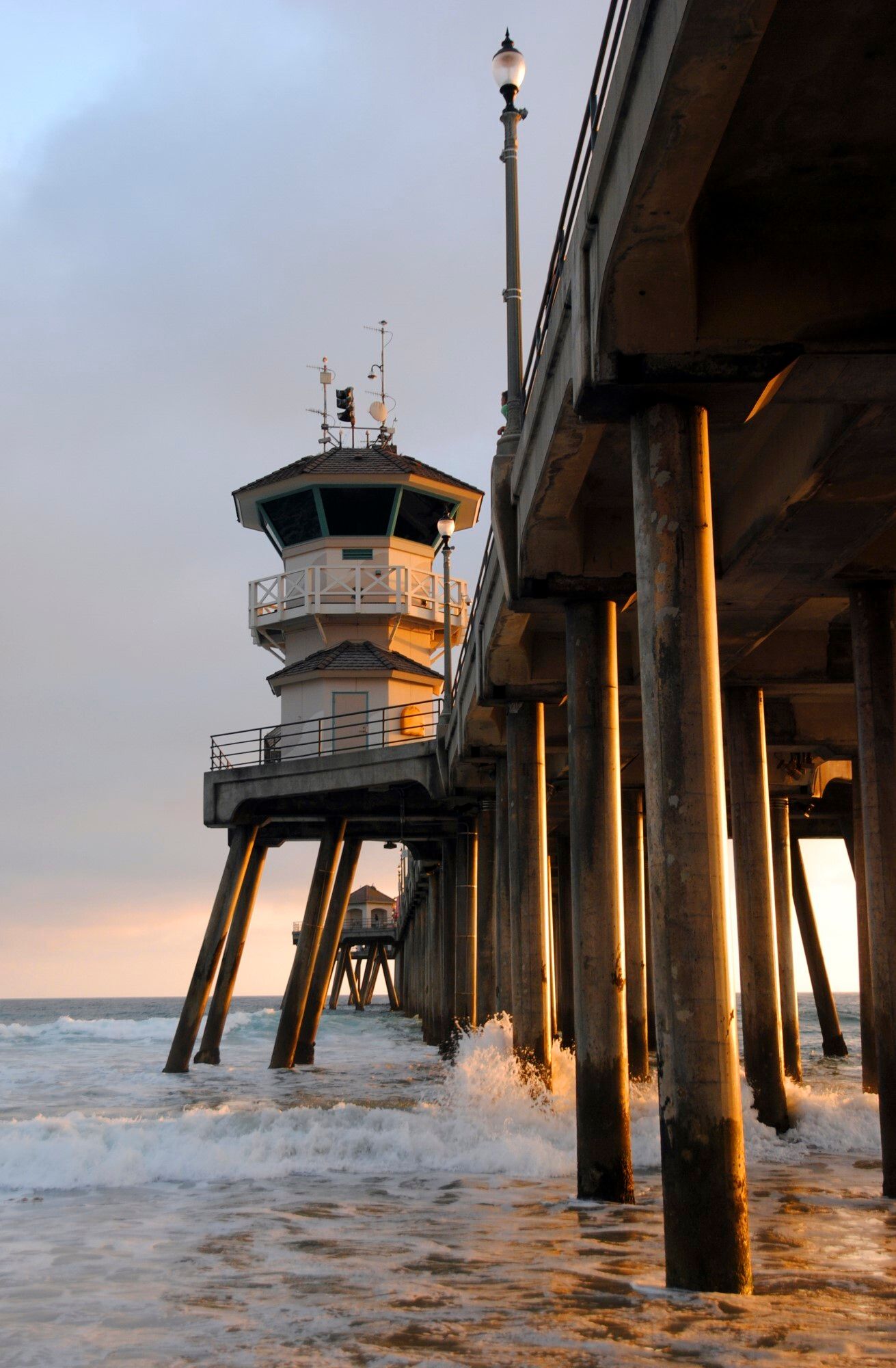 A pier with a lifeguard tower on top of it