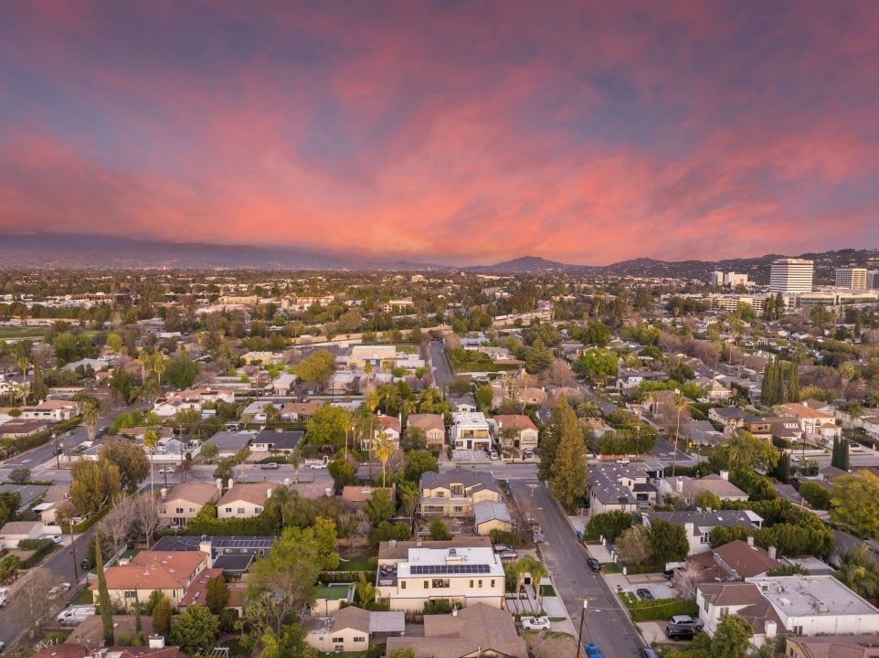 An aerial view of a residential area at sunset.