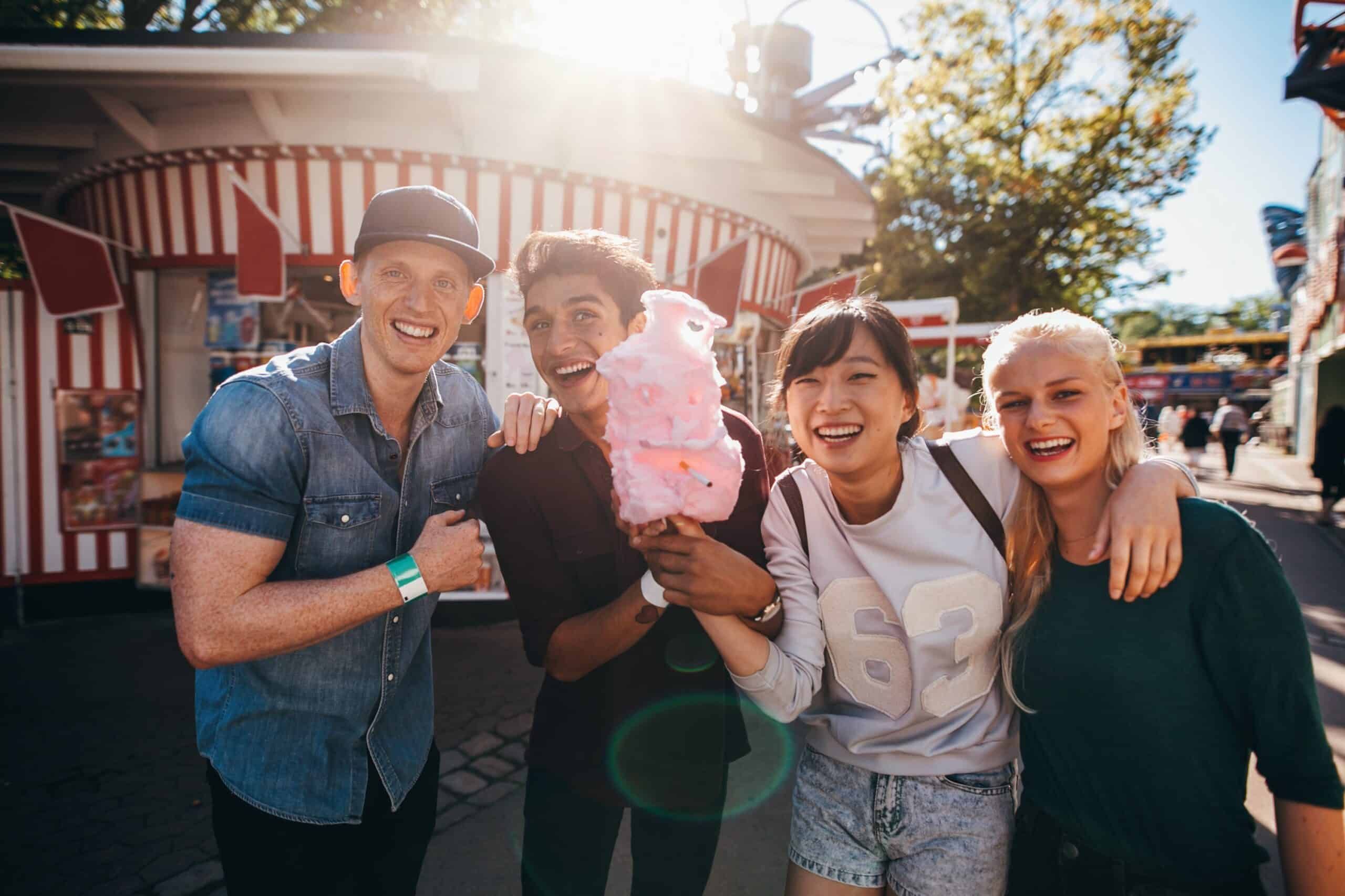 A group of people are posing for a picture at a carnival.