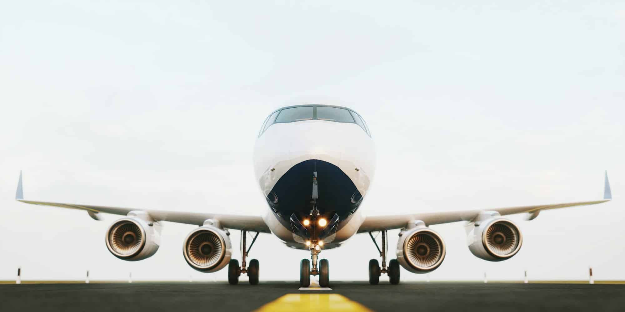 A large passenger jet is sitting on a runway ready to take off.