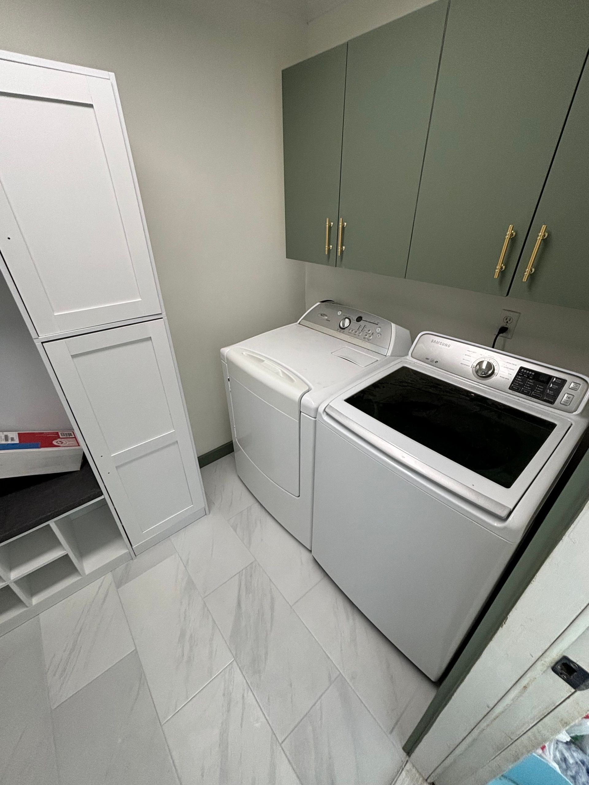 A laundry room with a washer and dryer in it.