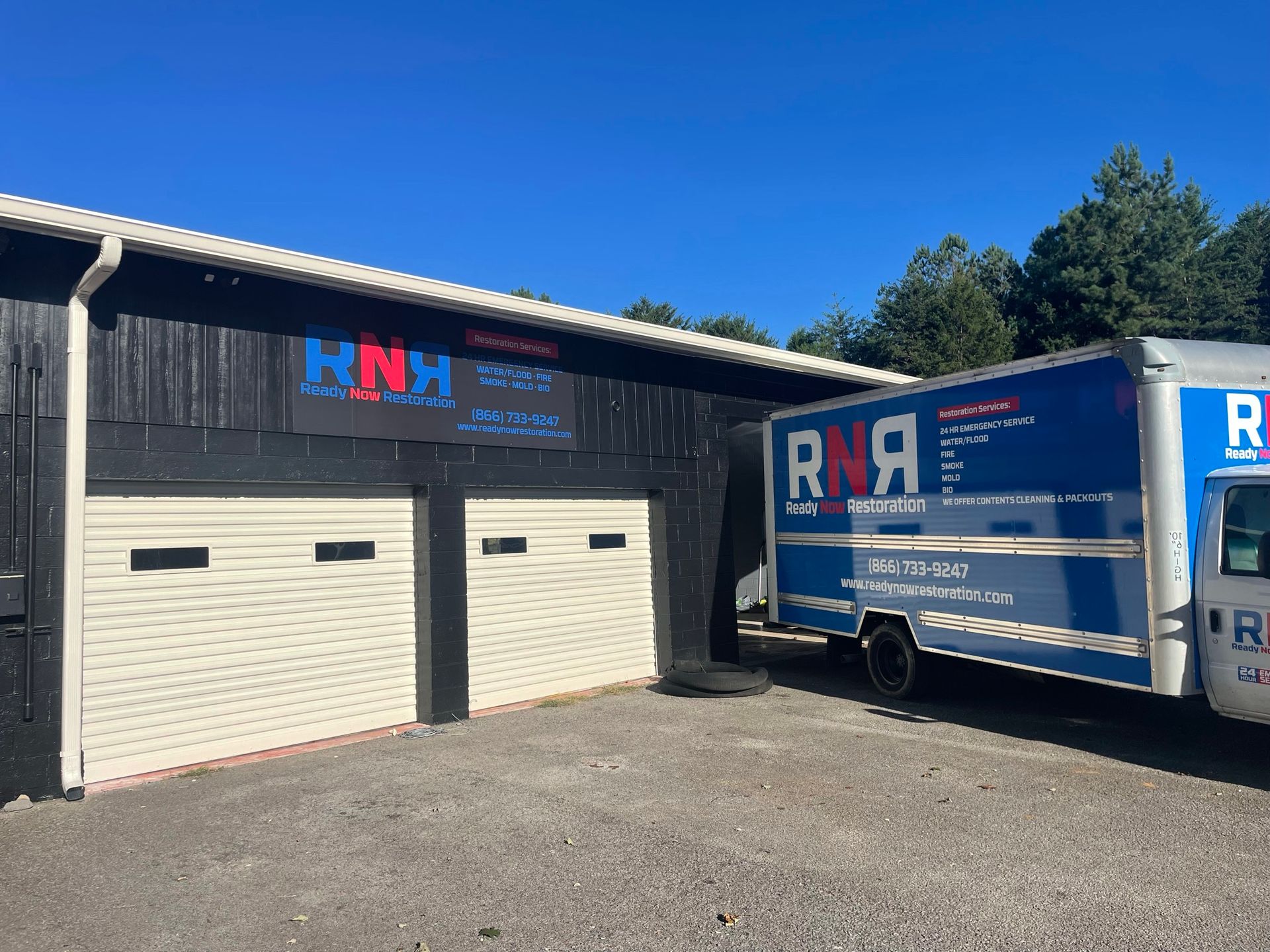 Two rna trucks are parked in front of a building