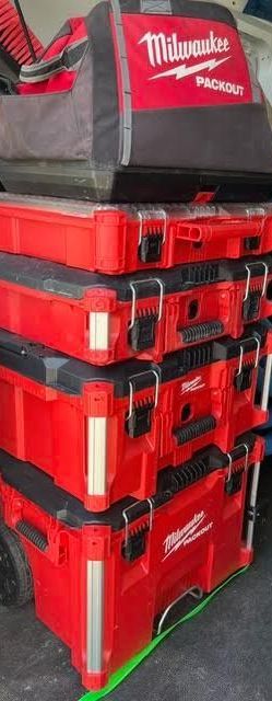 A stack of red milwaukee tool boxes sitting on top of each other.