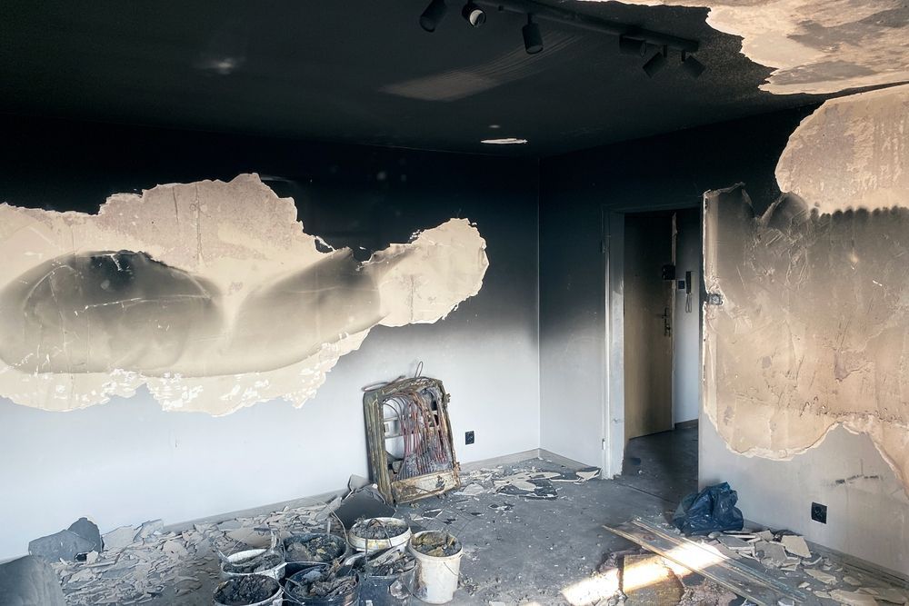 A room with a ceiling that has been damaged by a fire.