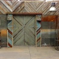 Rustic metal sliding doors and corrugated walls in an industrial interior