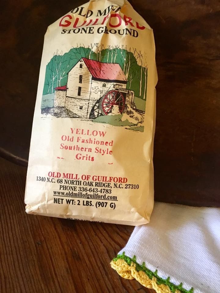 Bag of Old Mill stone ground yellow old fashioned style grits on a wooden table