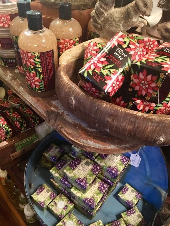 Bath display of floral-patterned soaps and lotions in woven baskets and trays