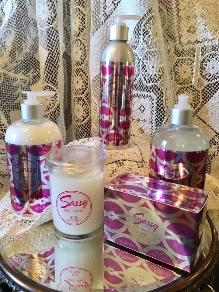Assorted pink and silver beauty products arranged on a lace backdrop
