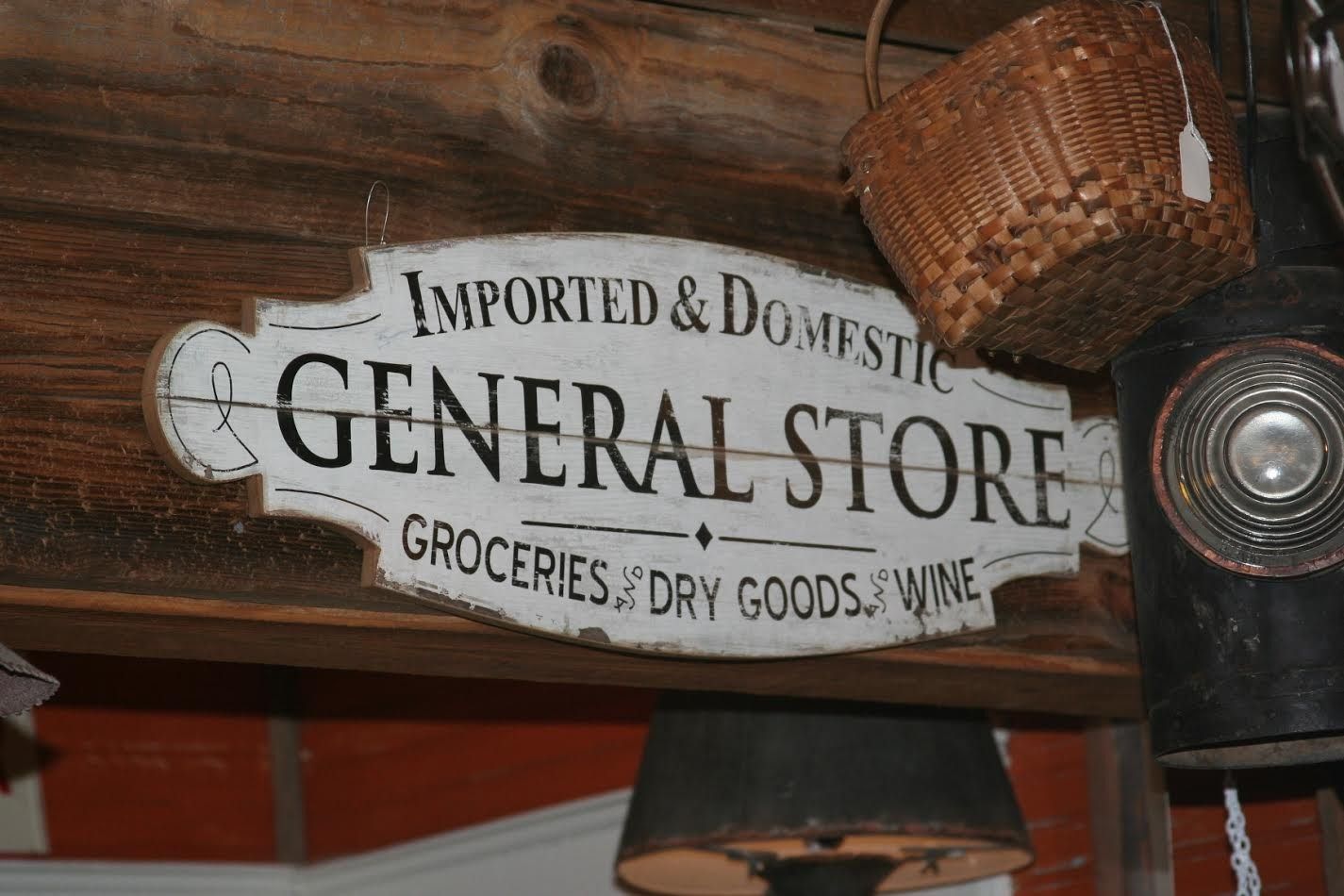 Vintage “General Store” sign with groceries and dry goods in a rustic wooden interior