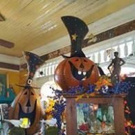 Halloween decorations with a smiling jack-o'-lantern and witch hats in a festive indoor display