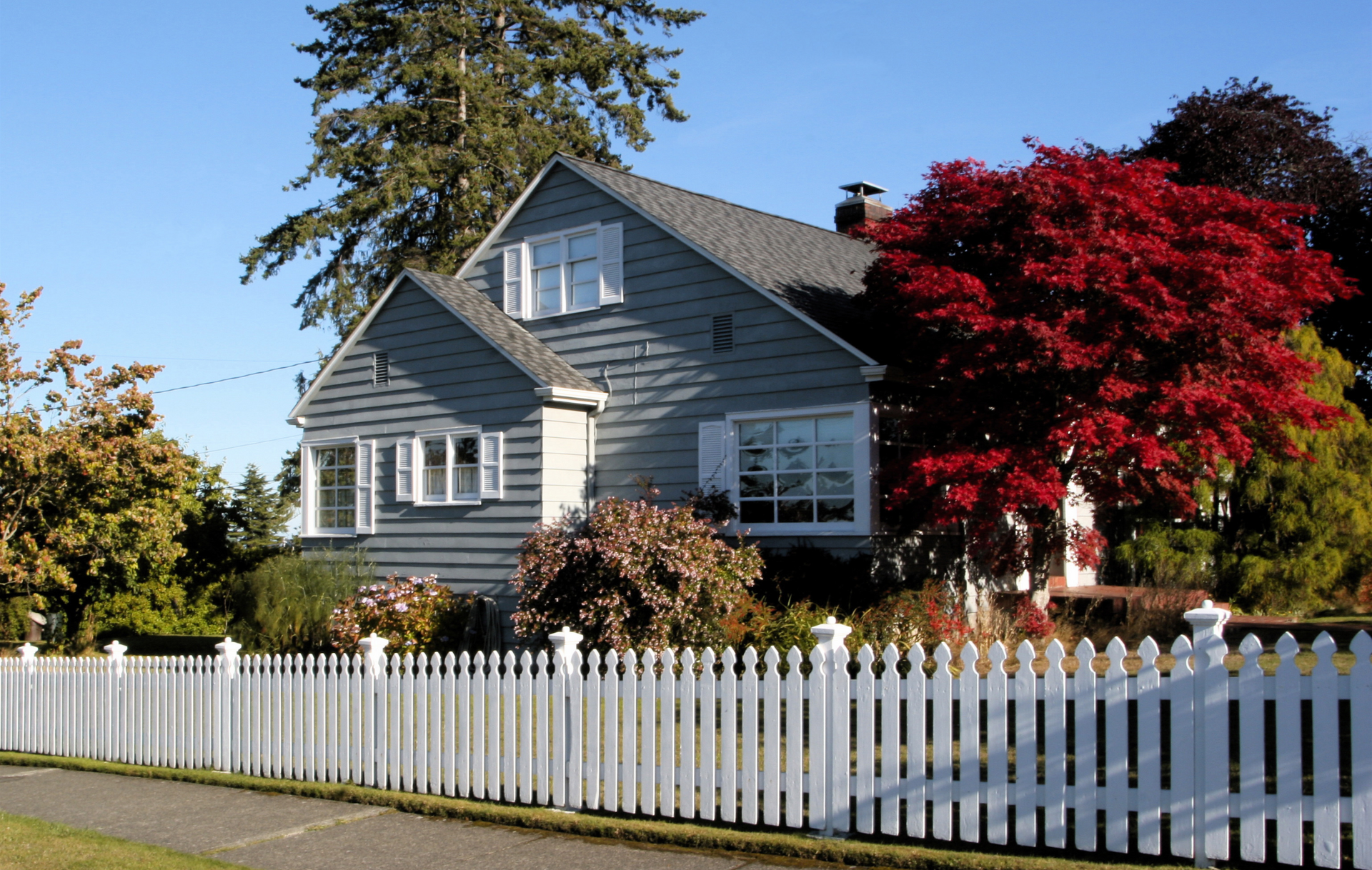 A house with a white picket fence around it