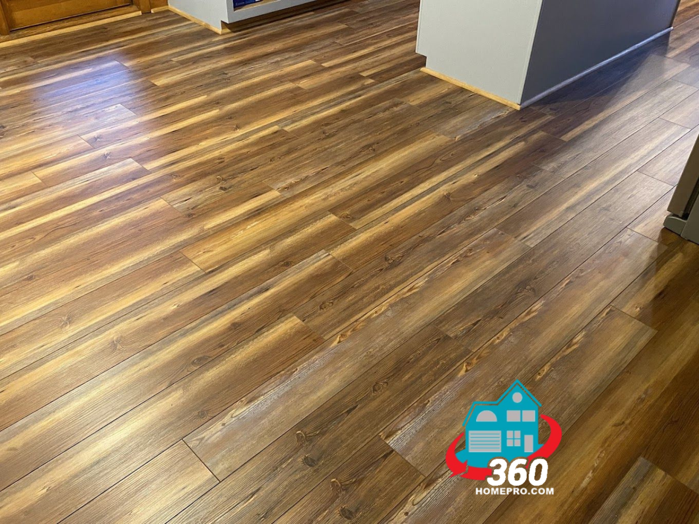 A close up of a wooden floor in a room.
